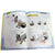 Robotis Dream instruction book open. Pages are white with a blue border in the grid shape pattern of the pieces. The pages show step-by-step instructions on creating the rabbit robot.