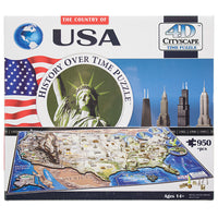 The U S A, History Over Time Puzzle box. The box is mainly white with a blue and white globe in the top-left corner. Across the middle is an American flag, The Statue of Liberty surrounded by a round border with the title inside, and a city scape. Below is the actual puzzle, put together, with several famous building pieces off to the side.
