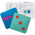 2 Tiny Polka Dot game cards are placed over the white instruction cards that instruct you to “match the dots.” The left game card is blue with 3 hot pink dots in a grid. The right game card is turquoise with 3 red dots diagonally down the middle, looking like the 3 side of a die.