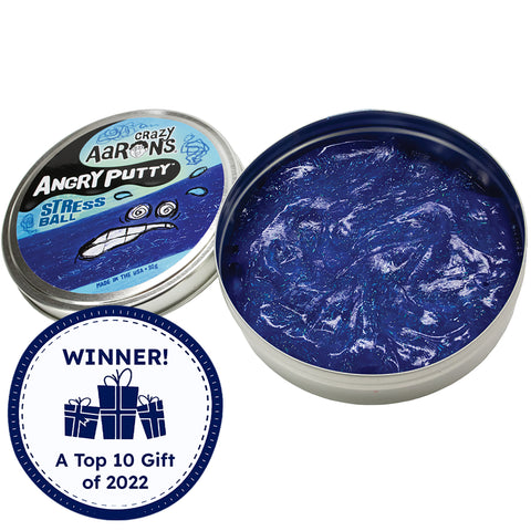 Crazy Aaron’s Angry Putty, Stress Ball. The large round tin has glittery dark blue putty swirled inside. The putty is reflecting the light and you can see the small, rectangular and circle shaped glitter inside the putty, shining in silver. The lid to the left shows a drawn stressed face with sweat beads splashing from the face on top of a band of putty. There is a Timberdoodle, Top gift of 2022, award badge over the image in the bottom-left.